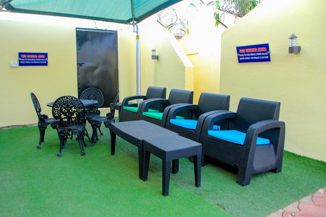 Outdoor smoking lounge with wicker chairs in the garden