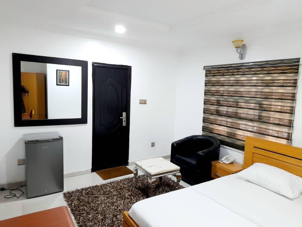 Executive room with mirror, mini-fridge and shaggy brown rug